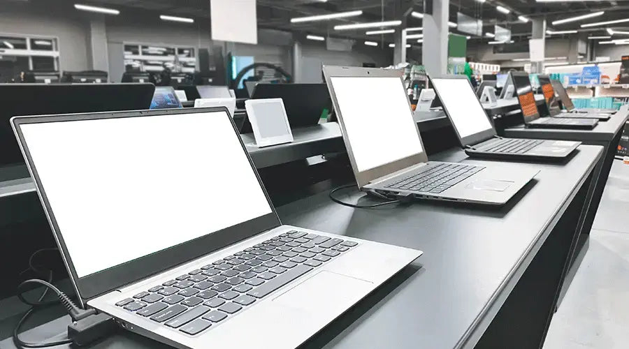 Assortment of refurbished MacBook and Windows laptops at PayMore Reston
