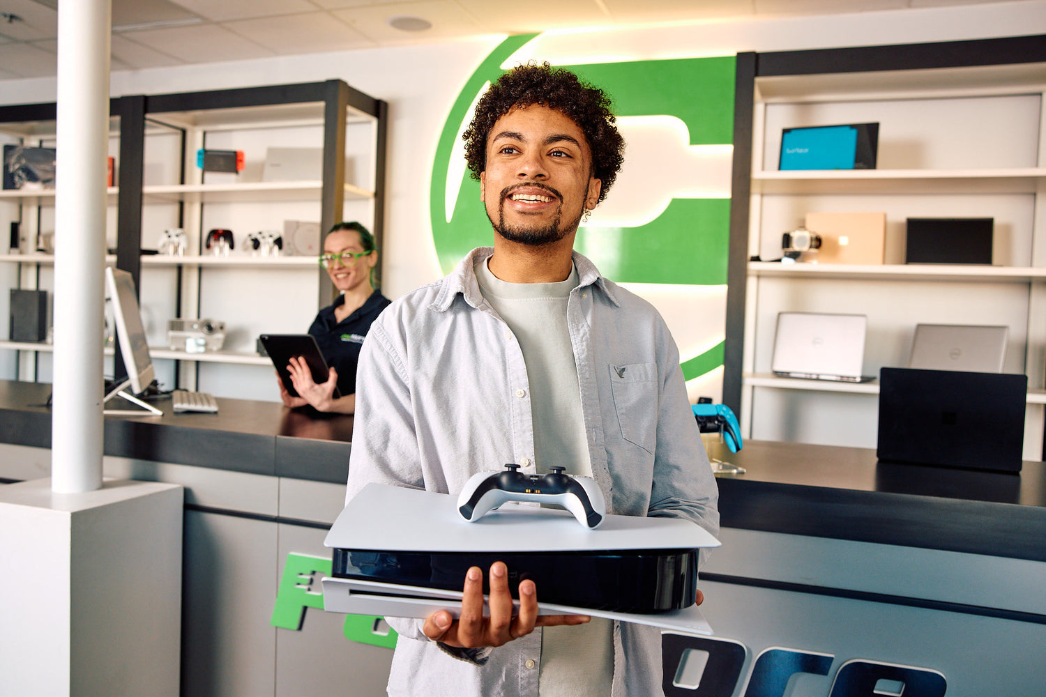 man in a paymore store holding a ps5