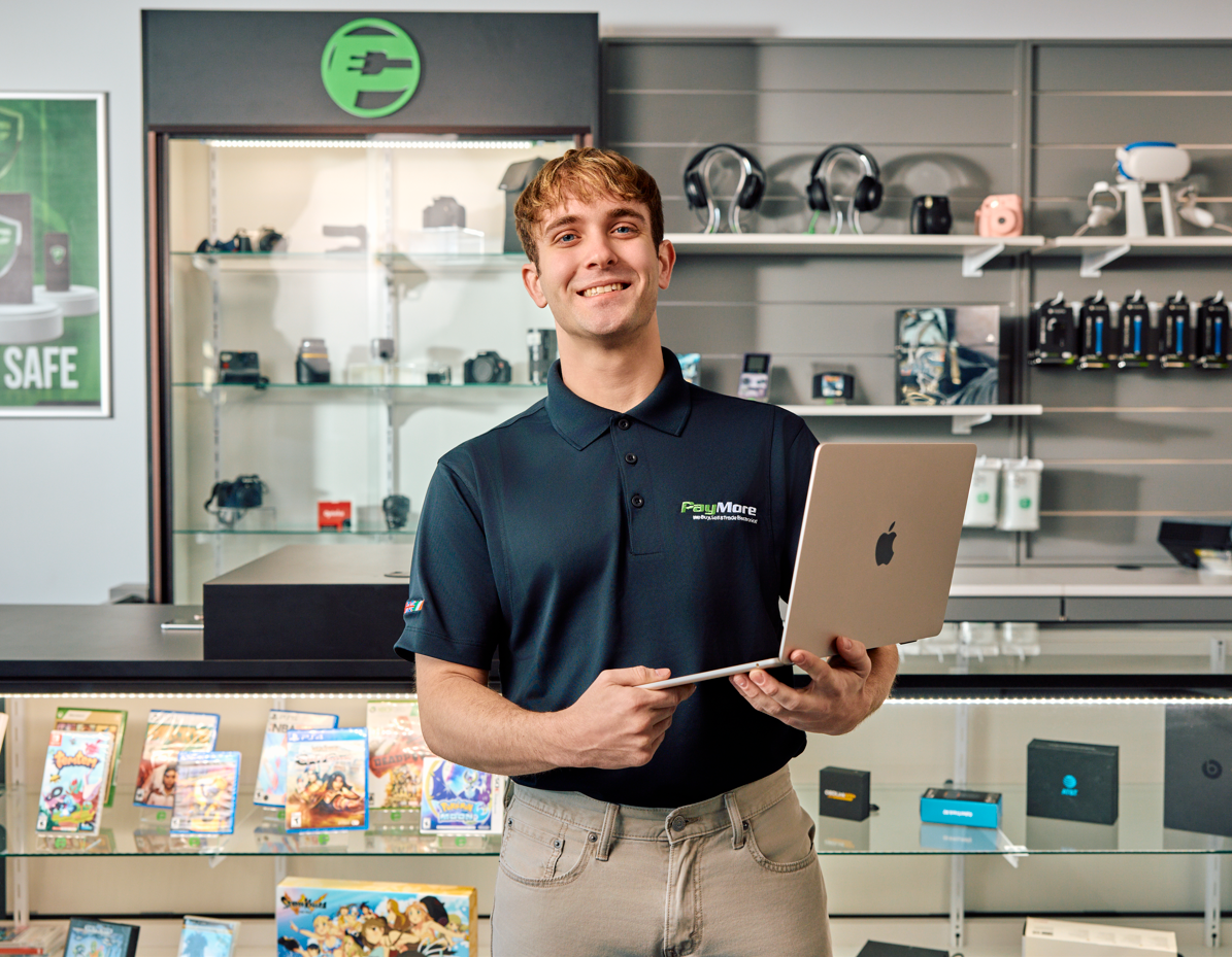 man holding a macbook pro